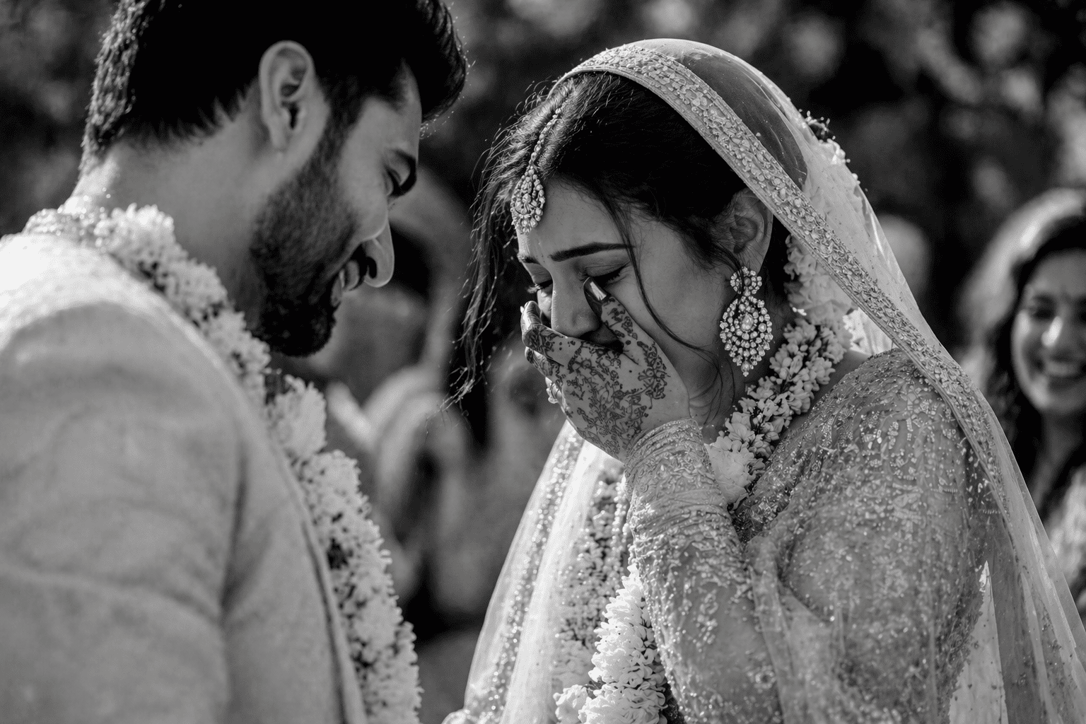 Black and white candid wedding photo of an emotional bride and groom sharing a heartfelt moment
